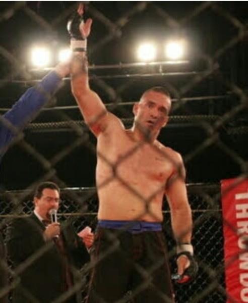 Fighter's hand raised after a professional Mixed Martial Arts bout