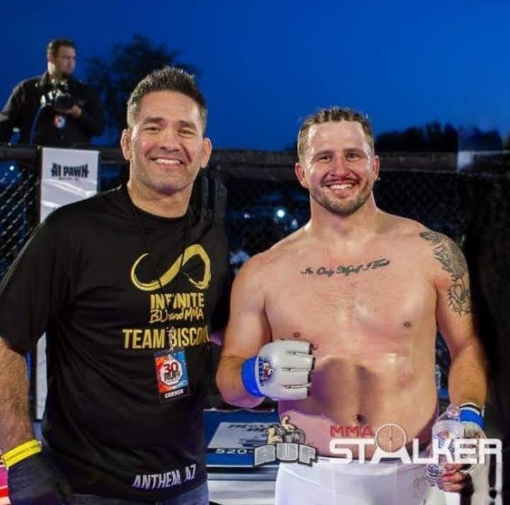 Coach and fighter after a professional Mixed Martial Arts bout